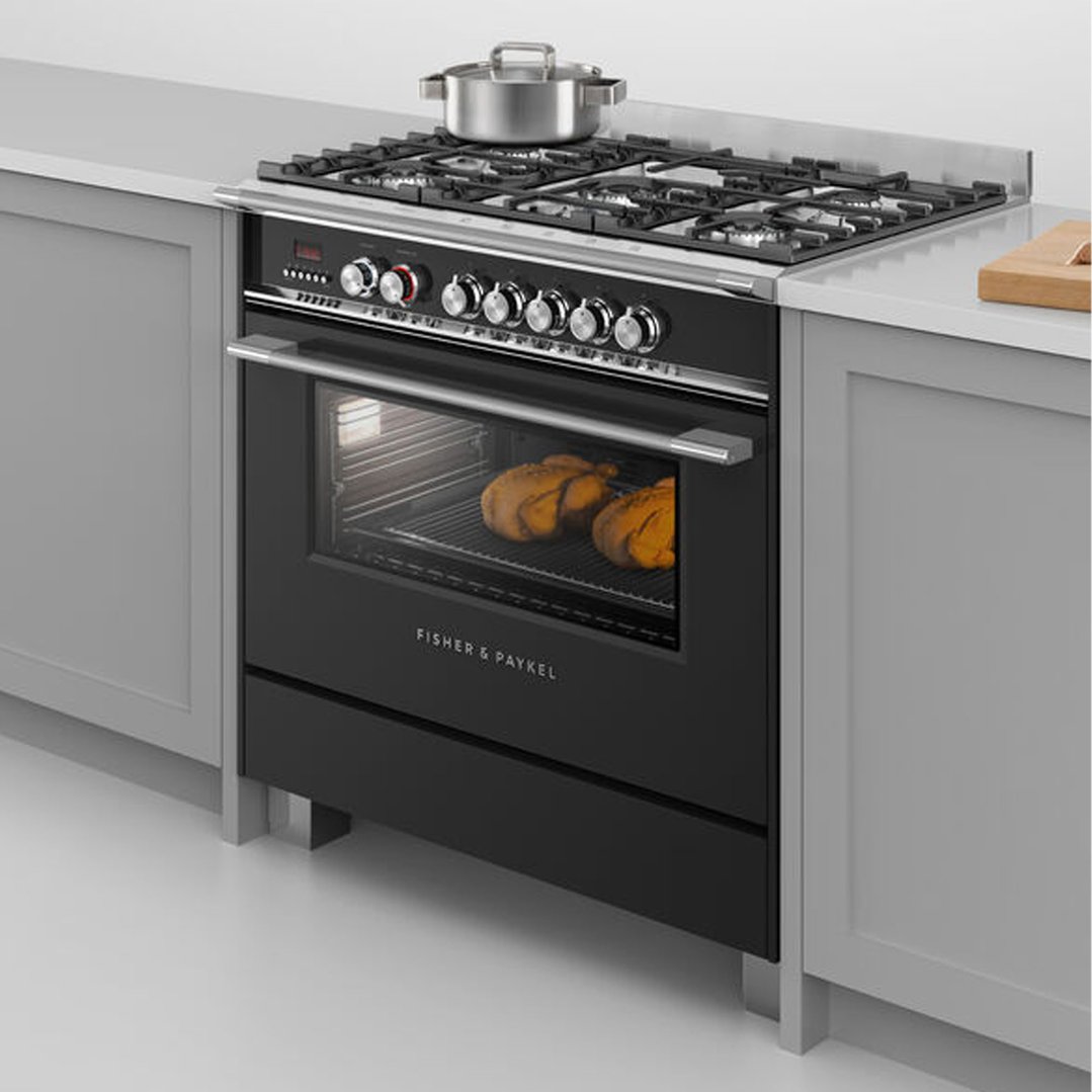 Black freestanding oven with gas cooktop in a kitchen setting