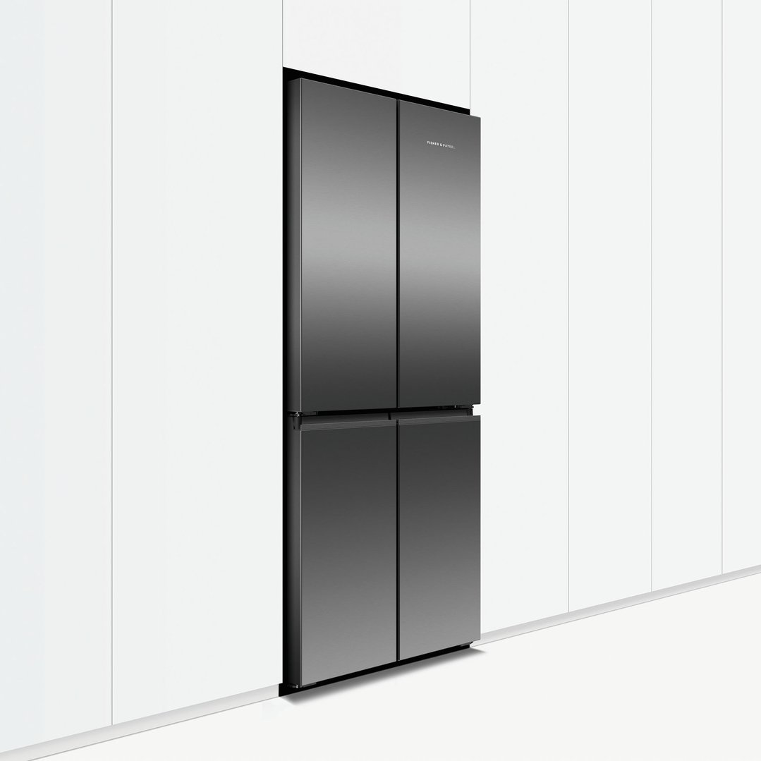 A dark quad door refrigerator freezer built into white kitchen cabinetry