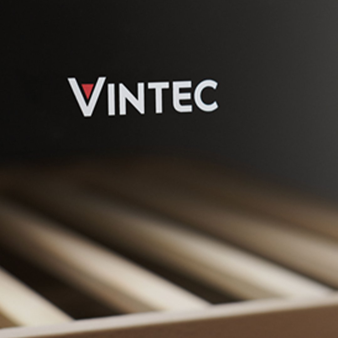 Close up of the VINTEC logo on a wine cabinet with wooden shelves