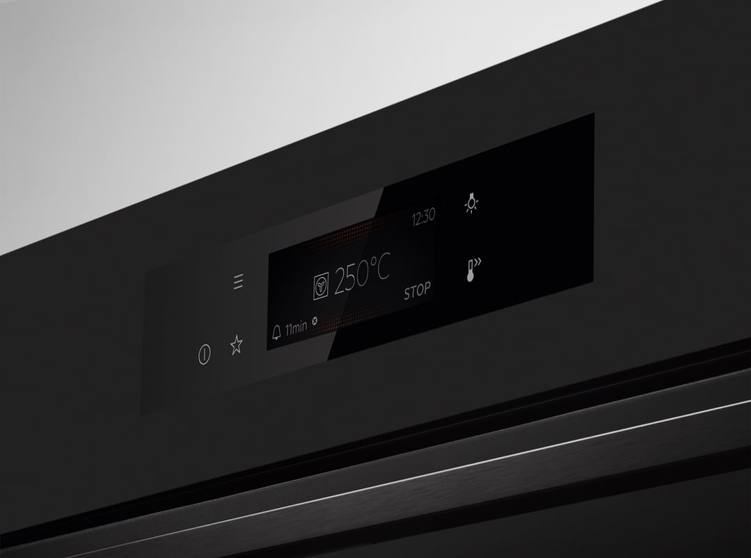 Close-up of an oven's digital display showing temperature and time