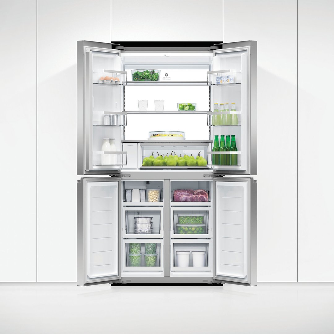 Open stainless steel quad door refrigerator freezer filled with food and drinks