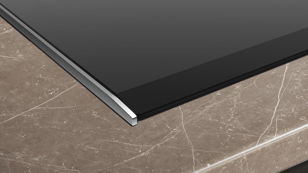 Close up of an induction cooktop on a marble countertop