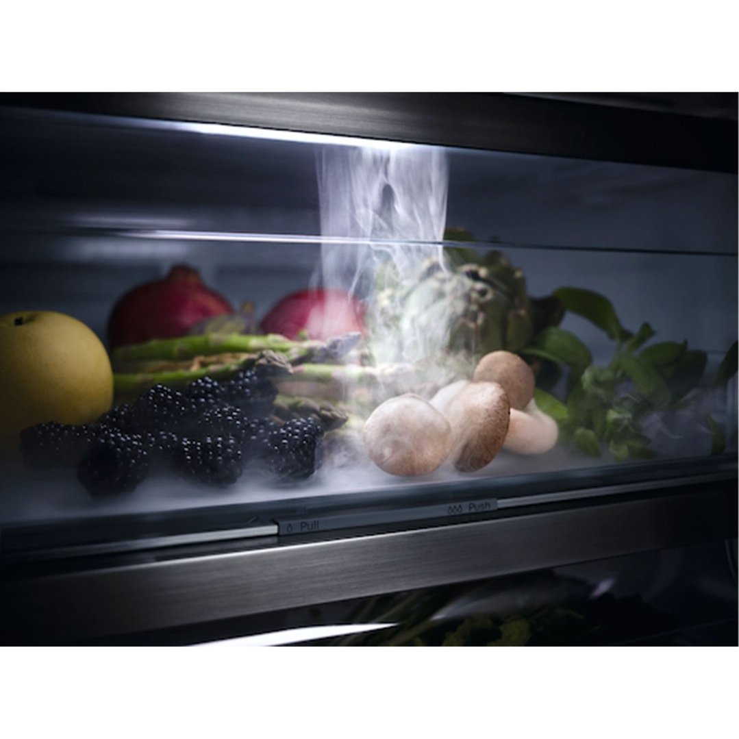 Close up of a fridge drawer with fruits and vegetables, with mist inside