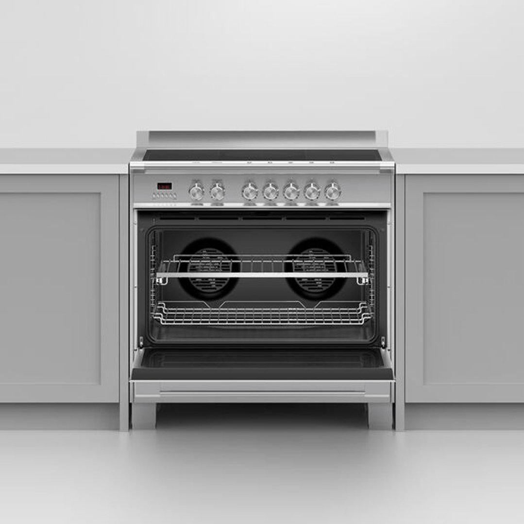 A stainless steel oven with its door open, built into a kitchen counter