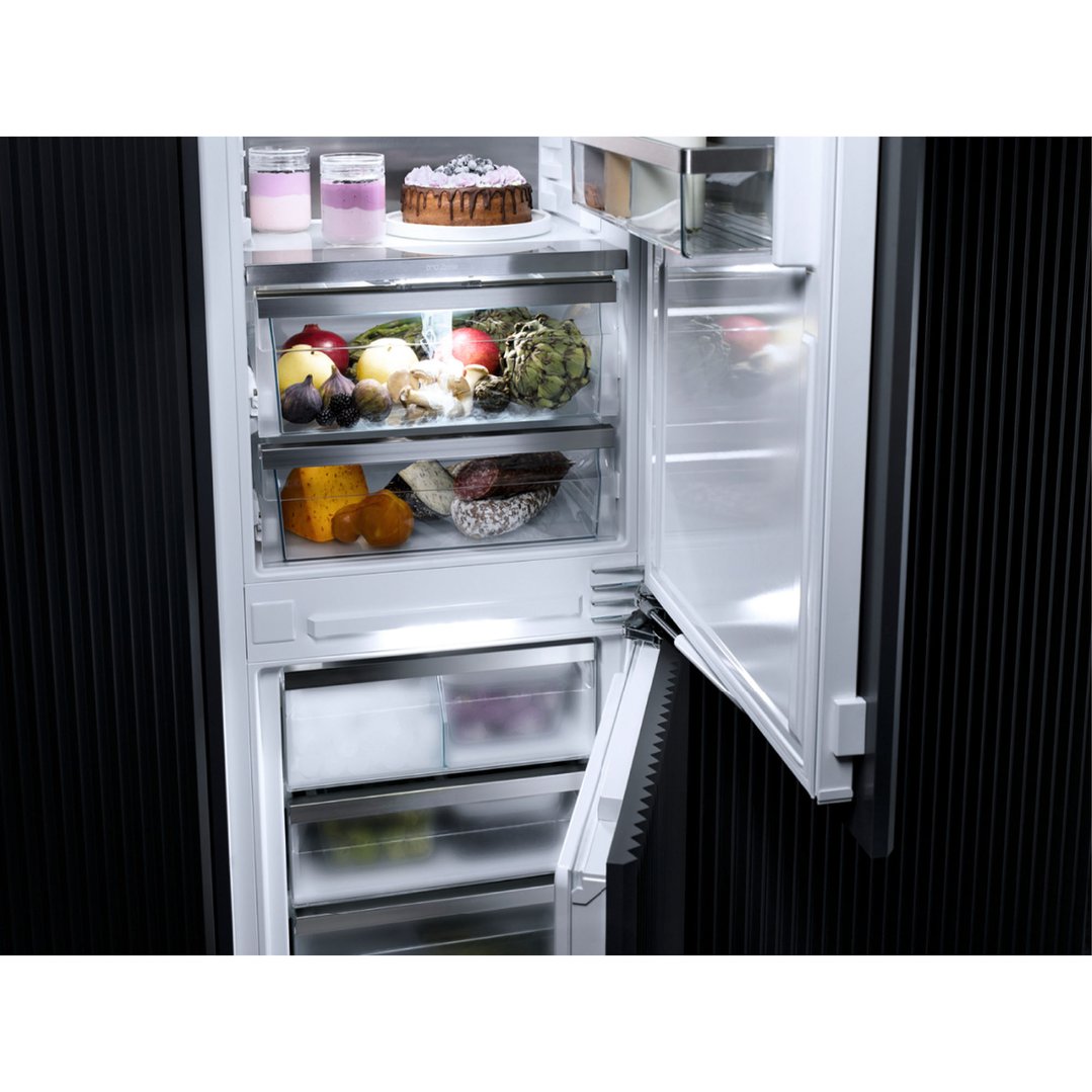 Open integrated bottom mount fridge freezer filled with food items