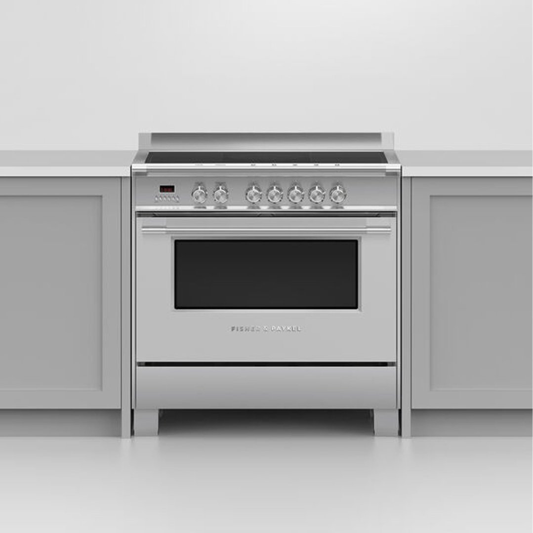 Stainless steel induction cooker built into light grey kitchen cabinetry
