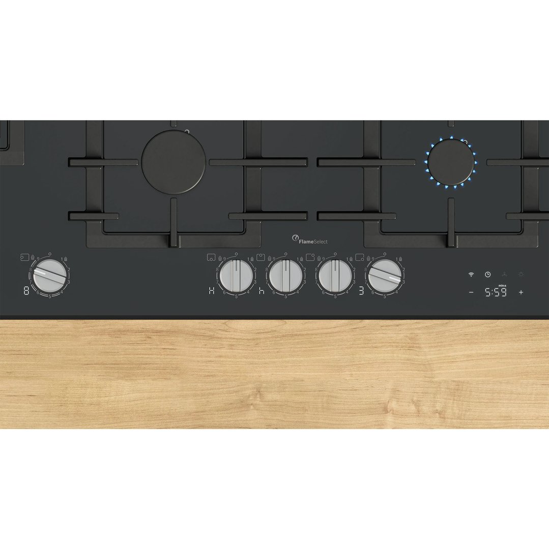 Black gas cooktop with five burners and controls, built into a wooden countertop