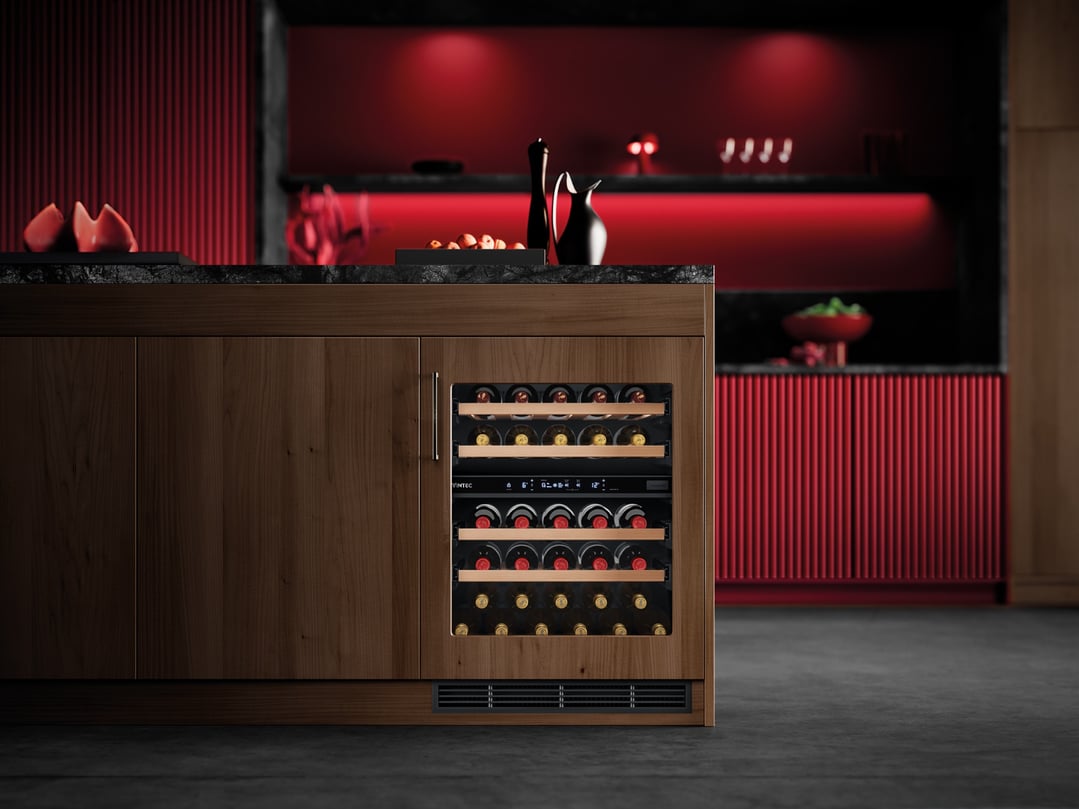 Built-in Vintec wine cabinet in a modern kitchen with red accents