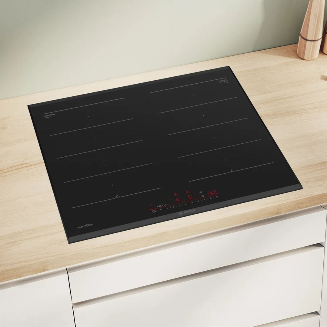 Black Bosch cooktop built into a light wood kitchen countertop