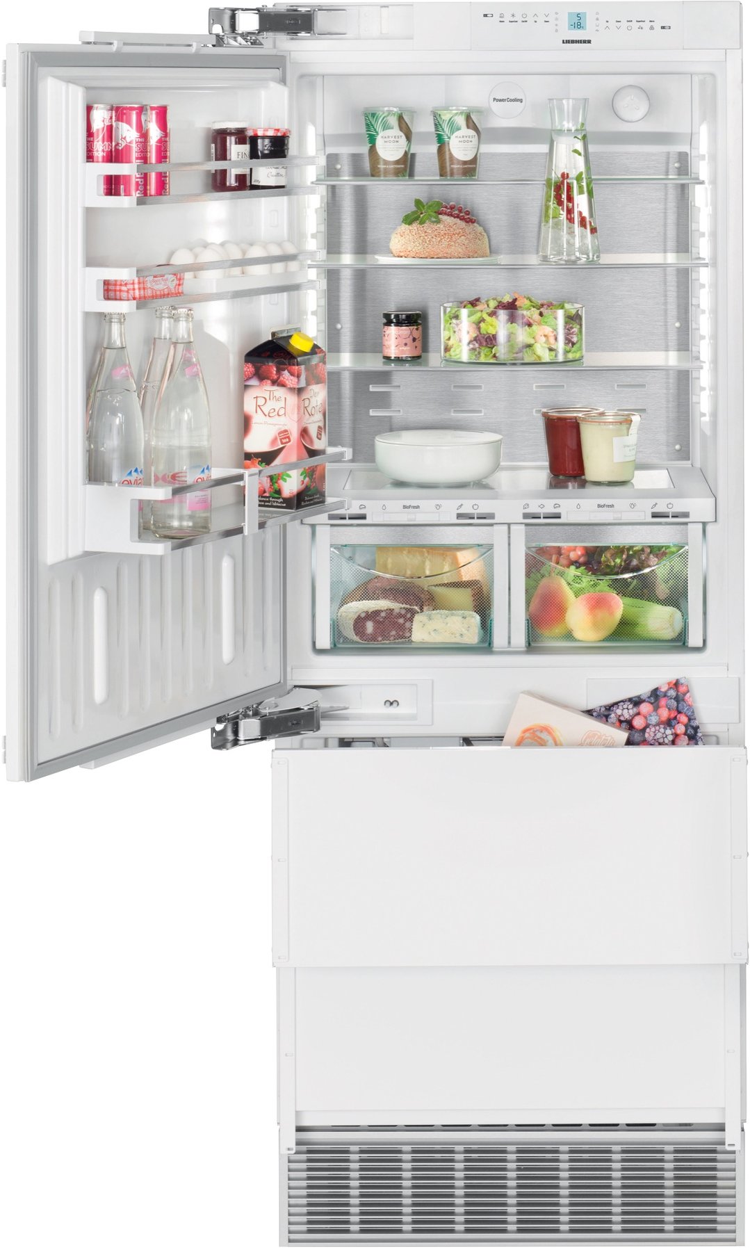 Open integrated bottom mount fridge filled with food and drinks