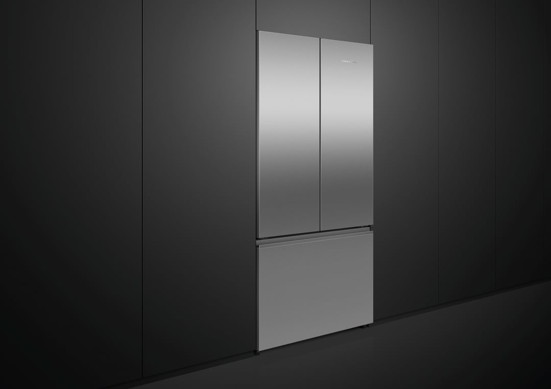 Stainless steel French door refrigerator freezer in a dark kitchen setting