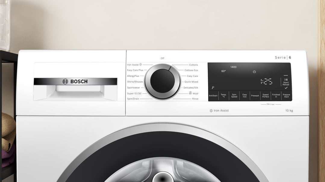 Close-up of a white Bosch washing machine control panel and door