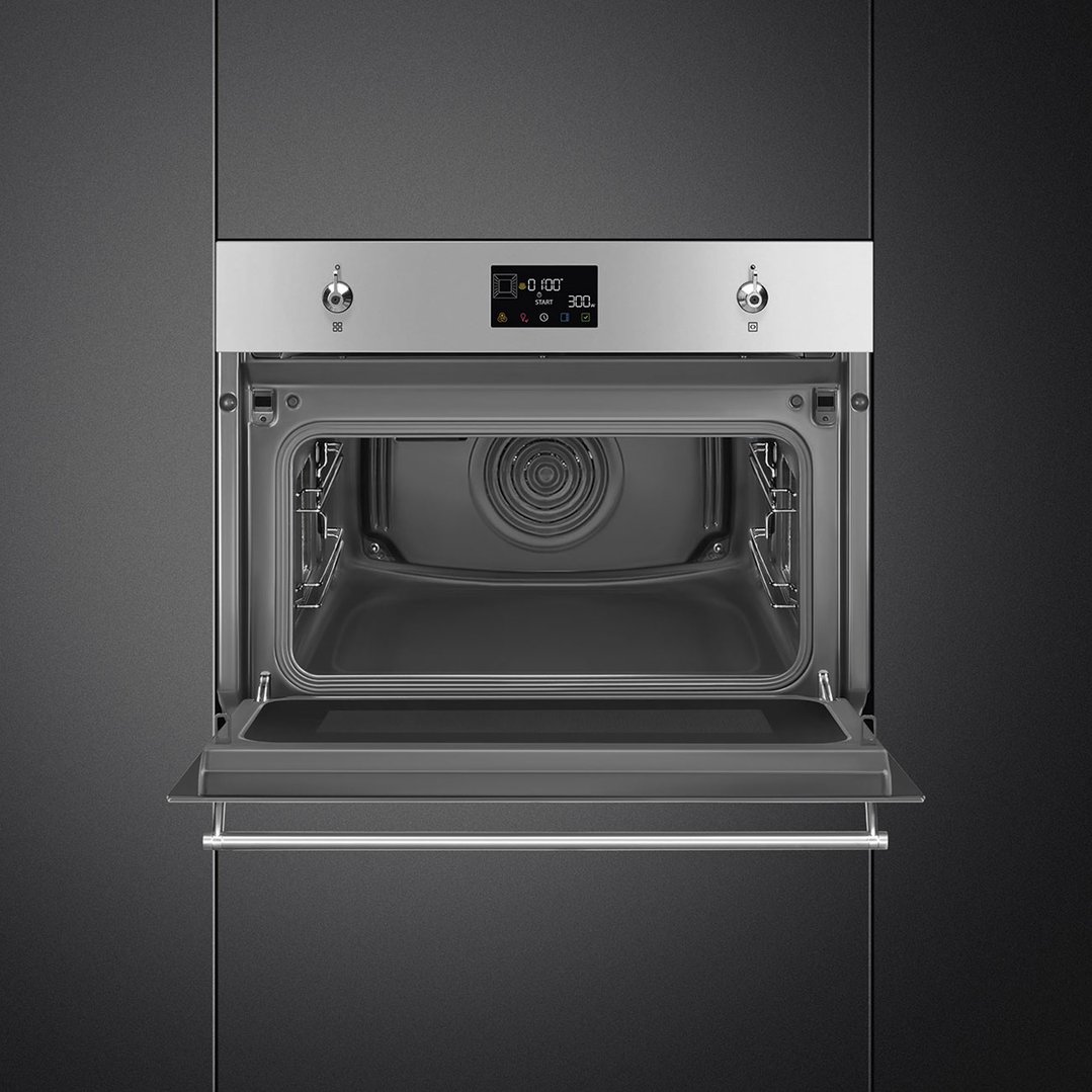 SMEG Compact Classic Speed Oven with door open, built into dark cabinetry