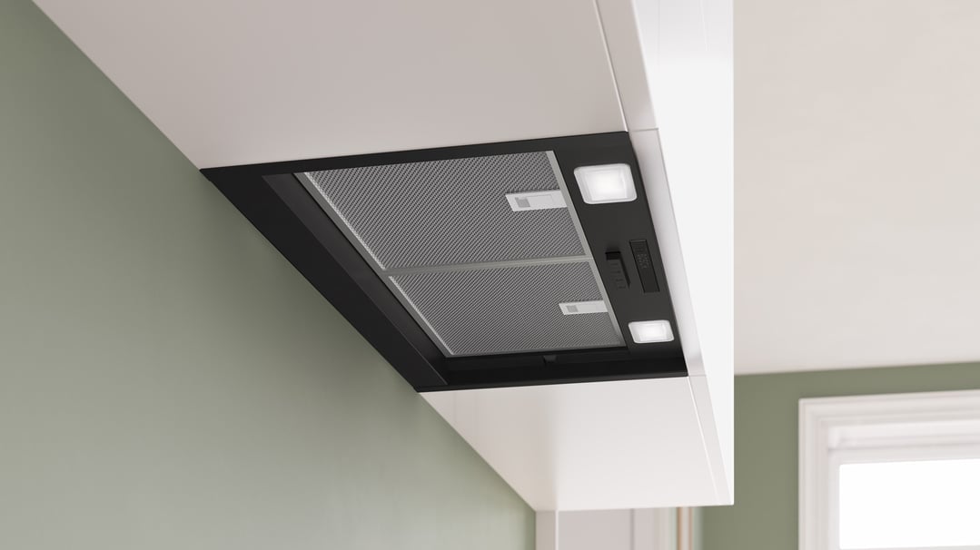 Integrated rangehood with lights and controls installed in a modern kitchen