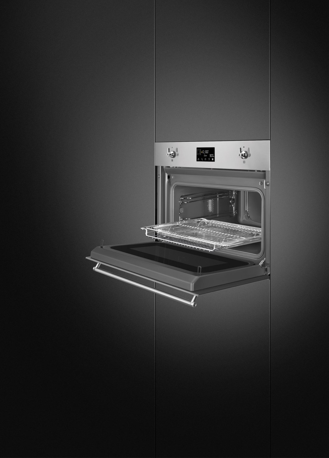 Built-in microwave with door open, showing interior racks in a dark kitchen