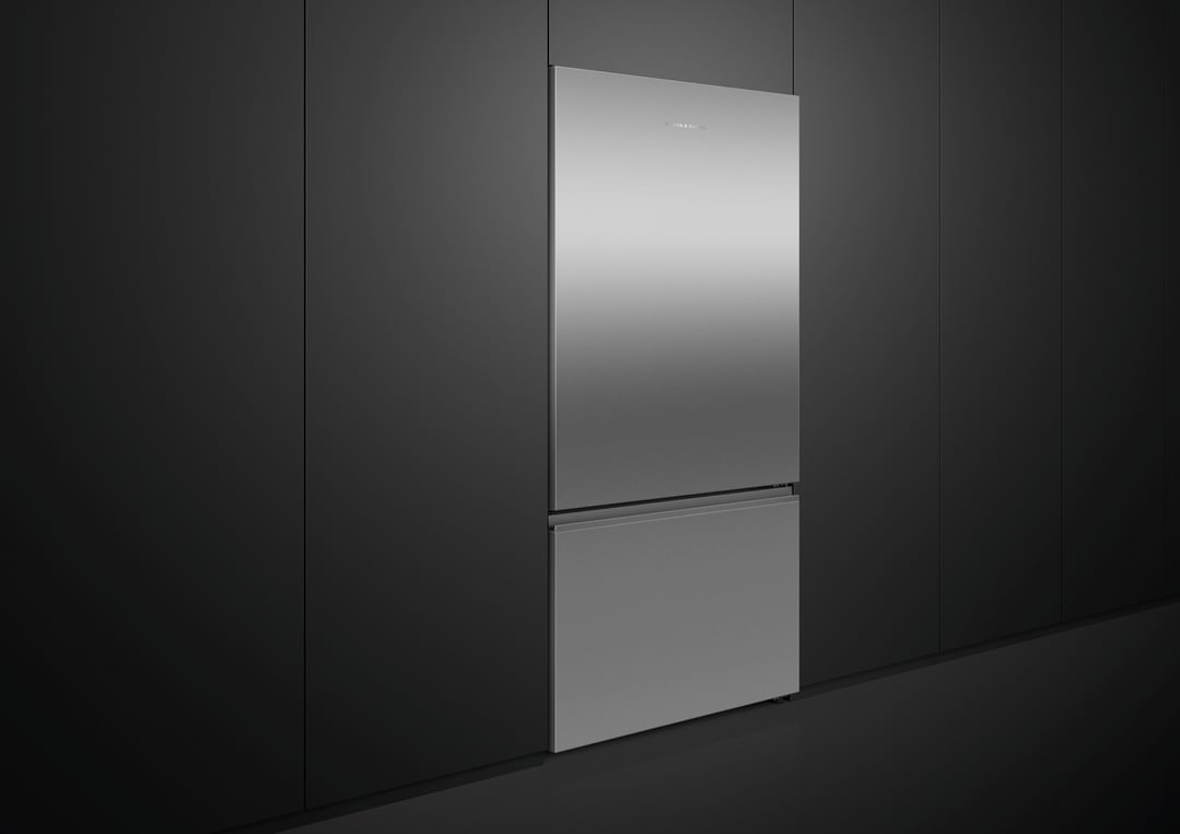 Stainless steel bottom mount fridge in a modern kitchen with dark cabinetry