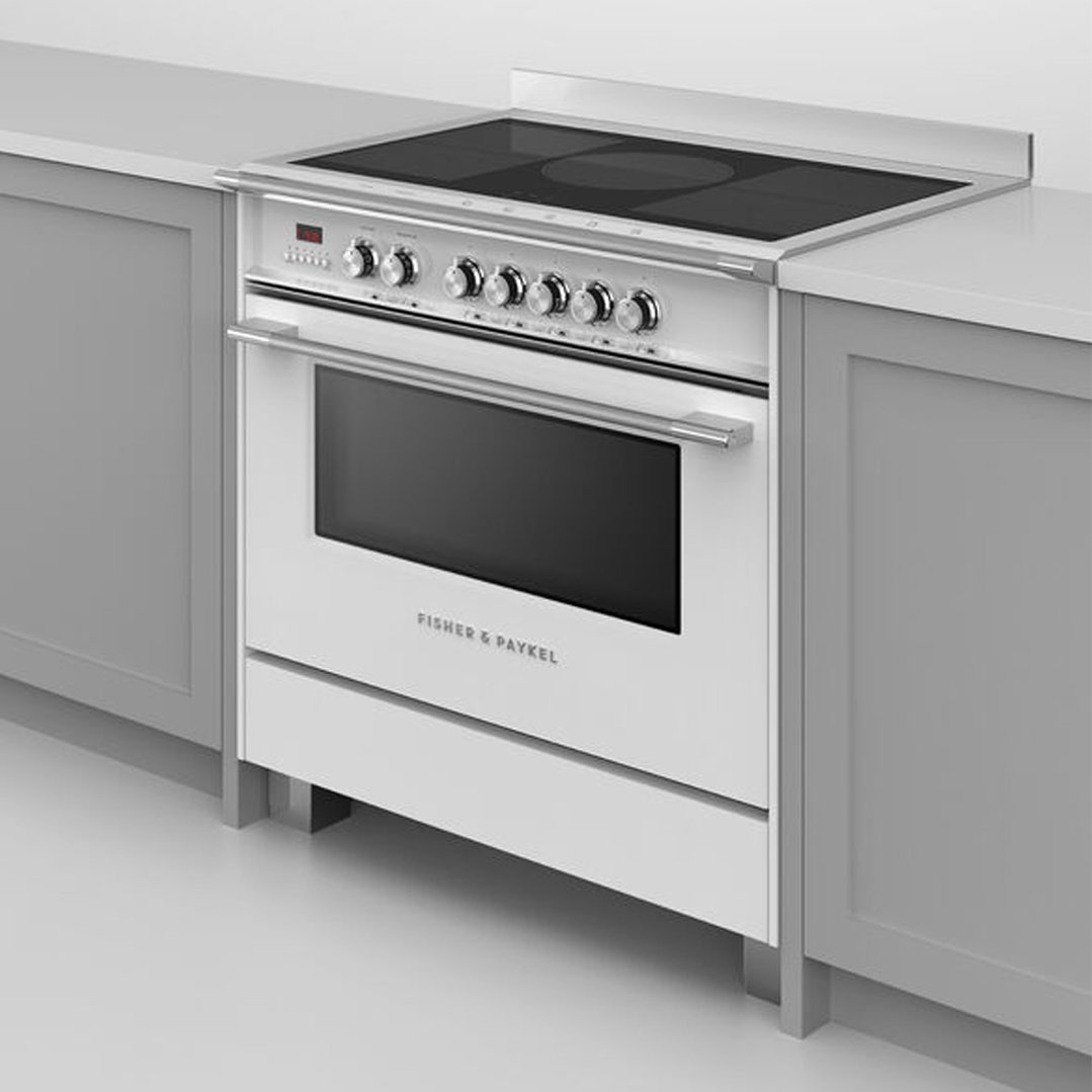 White induction cooker built into a kitchen counter with grey cabinets