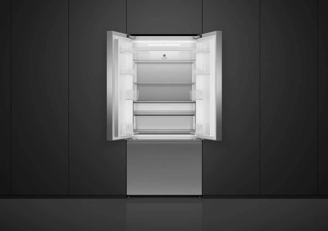 Open Fisher & Paykel French Door Refrigerator Freezer in a dark kitchen