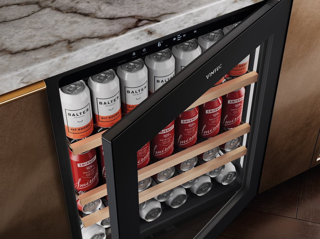 Open VINTEC beverage centre filled with cans, built into a kitchen counter