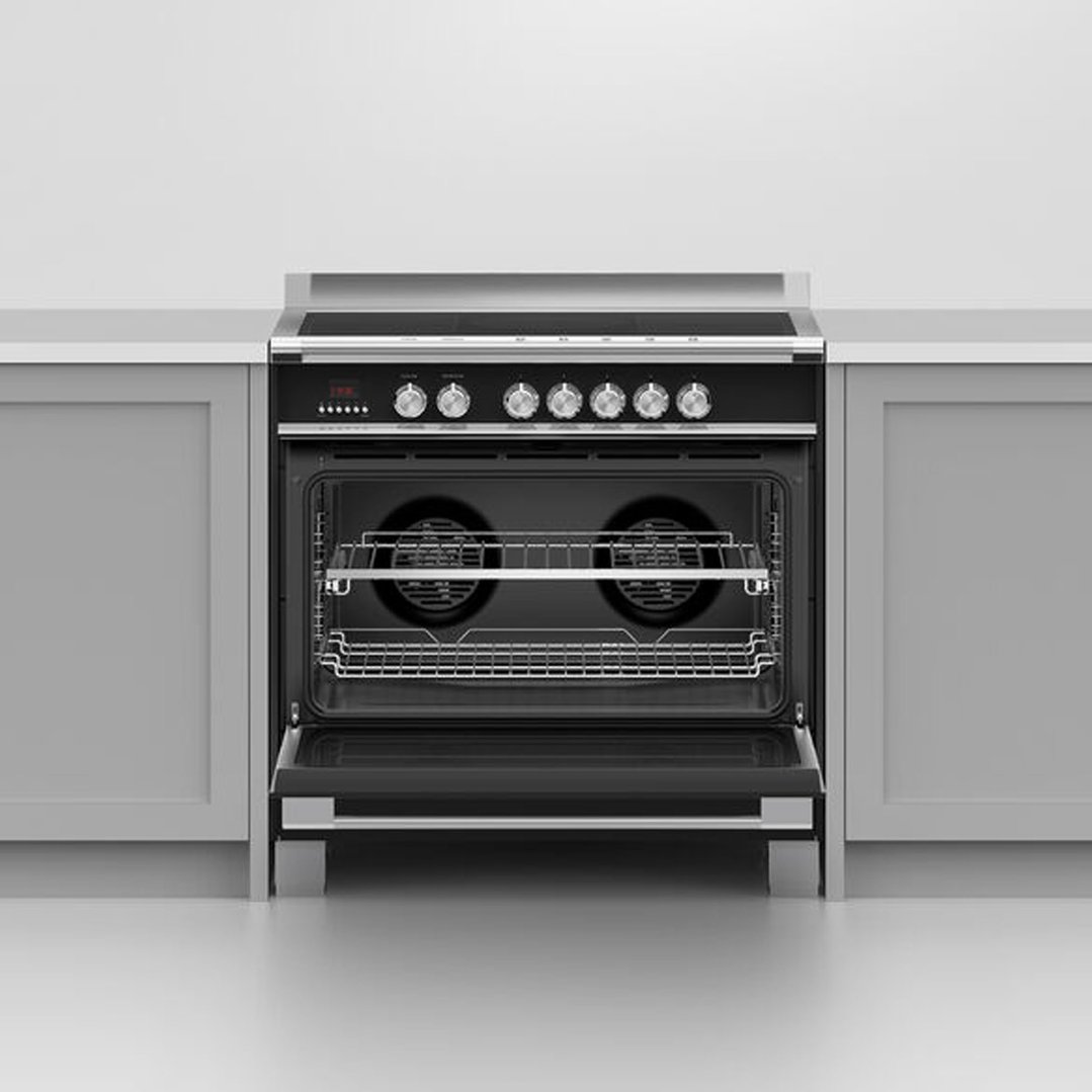 Black 90cm induction cooker with oven door open in a kitchen setting