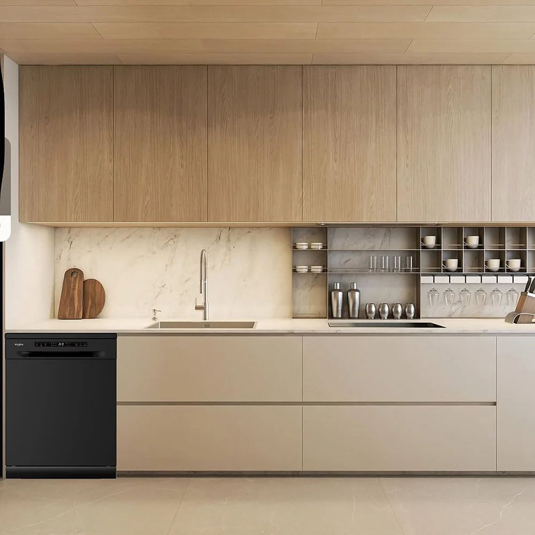 Black Whirlpool dishwasher built into a modern kitchen with light wood cabinets