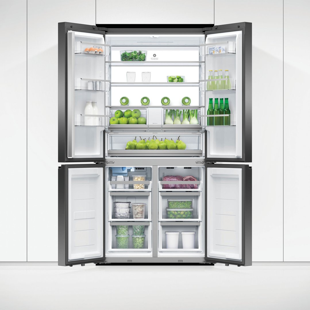 Open quad door refrigerator freezer filled with fresh produce and beverages