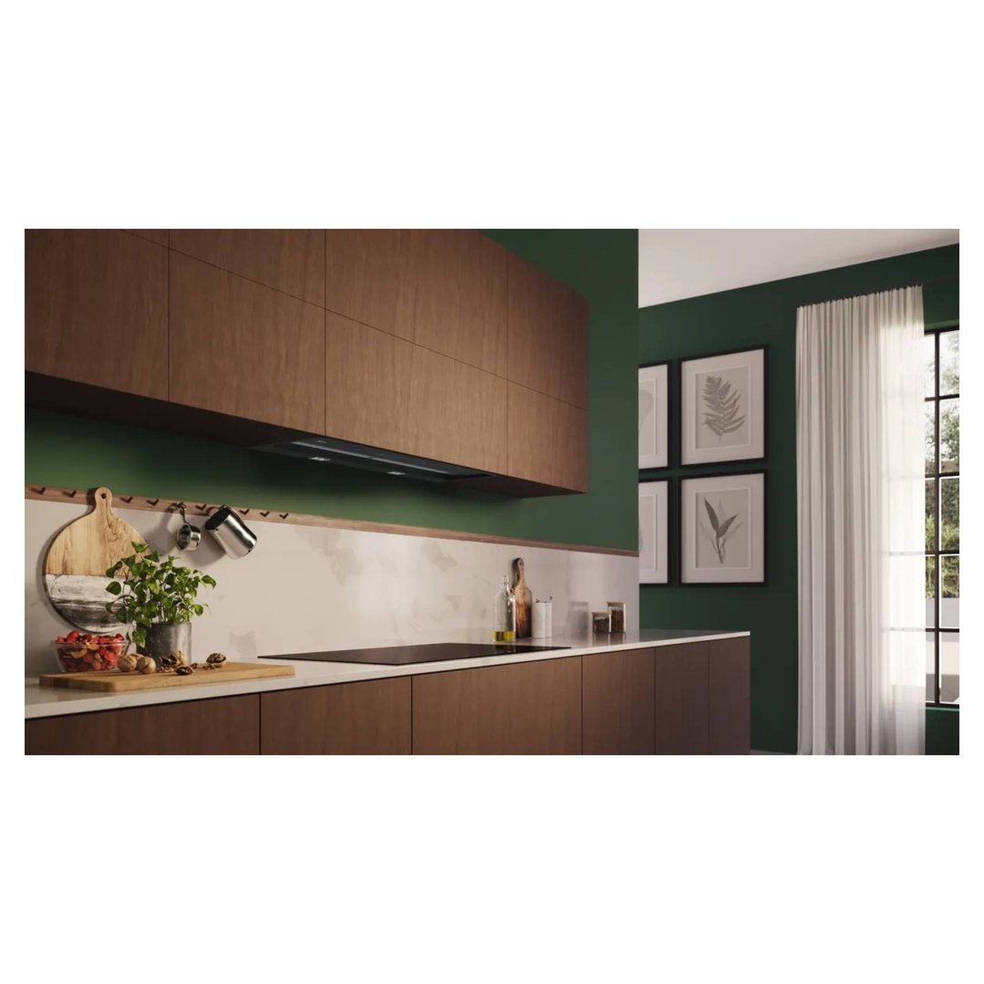 Integrated design rangehood in a modern kitchen with dark green walls