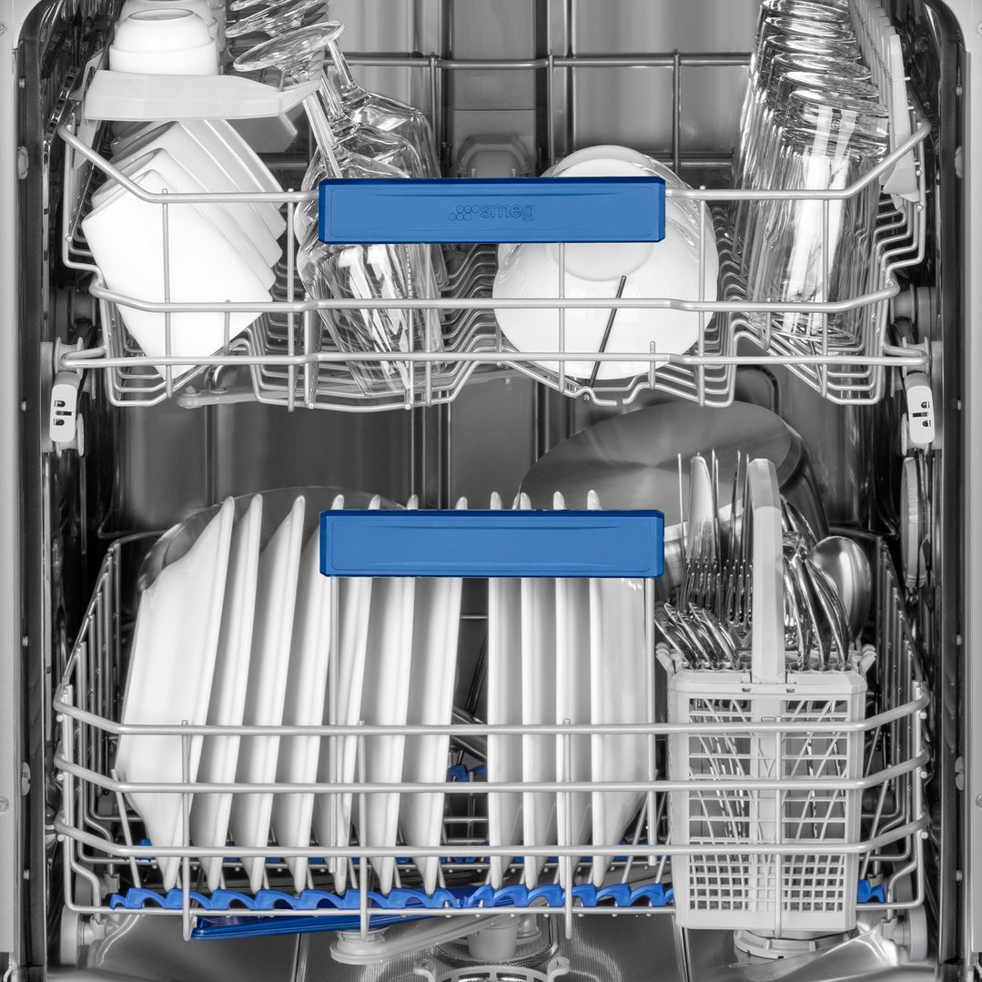 Inside view of a Smeg dishwasher with dishes and cutlery loaded