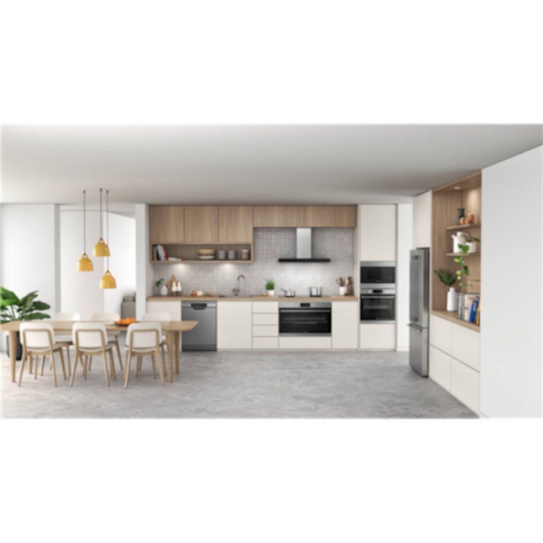 A microwave oven built into a modern kitchen with dining area