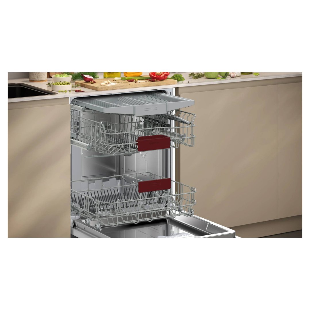 A fully-integrated dishwasher with open racks in a modern kitchen setting