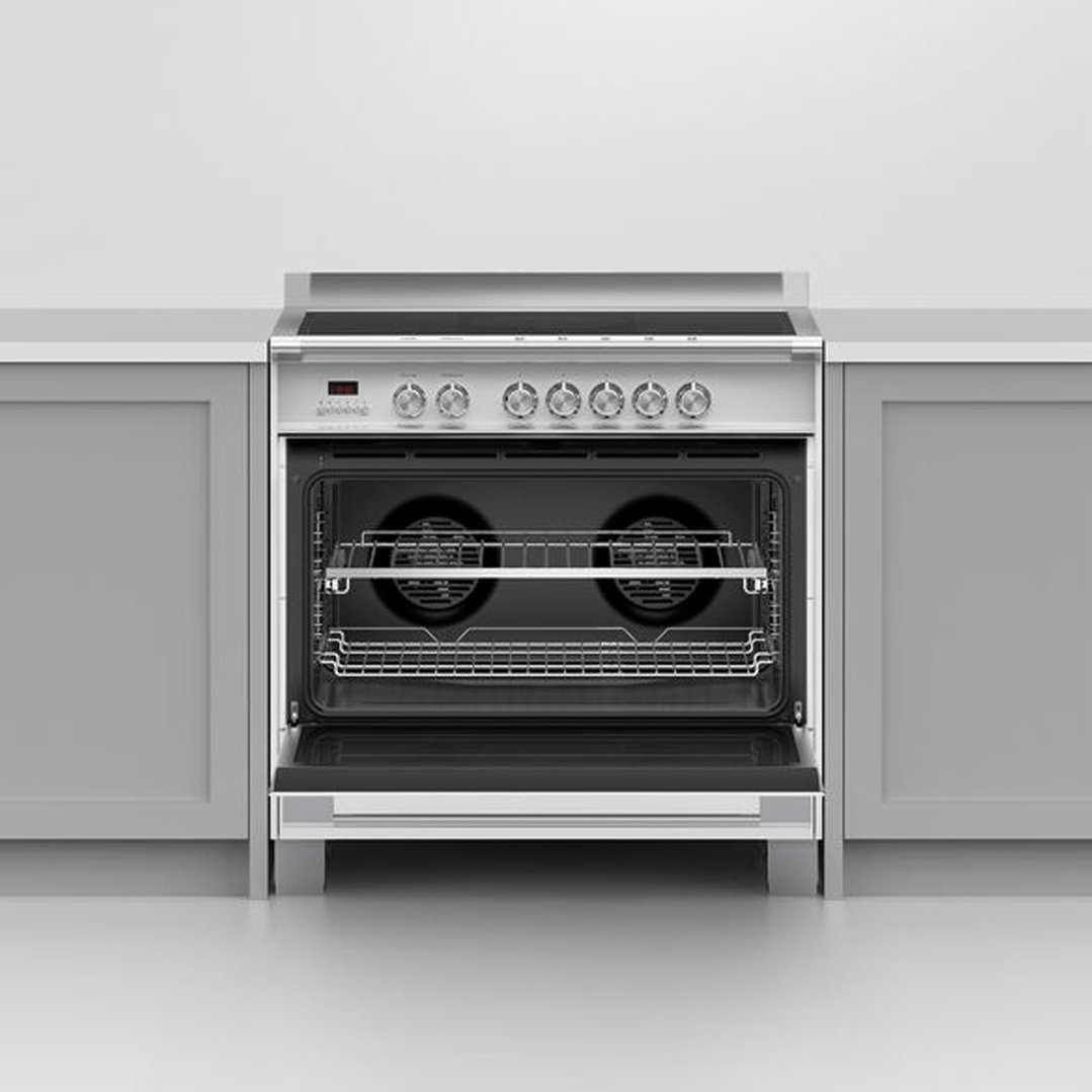White oven with open door, showing racks, installed in a kitchen