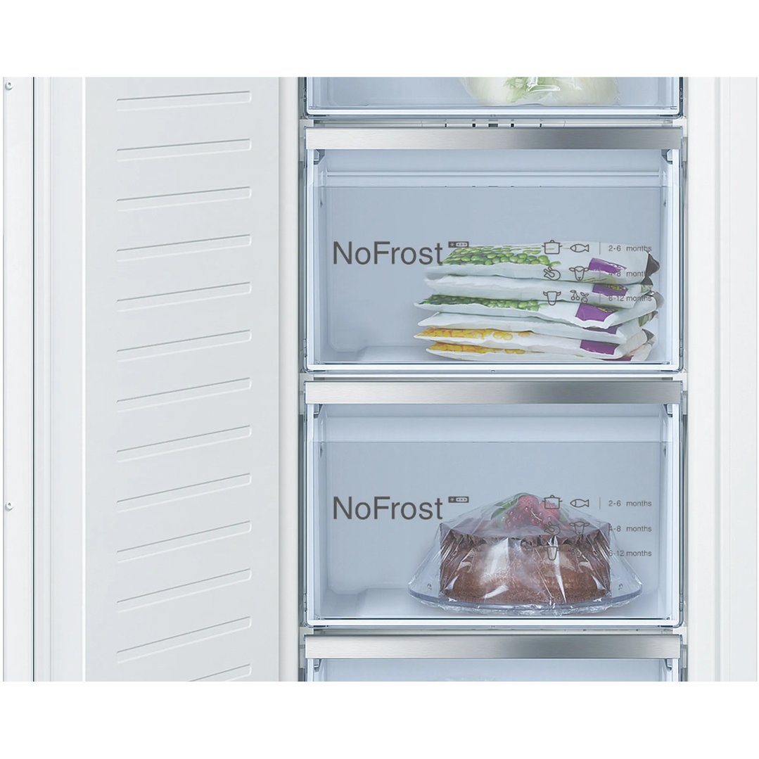 Close up of the interior of a built-in freezer with food items