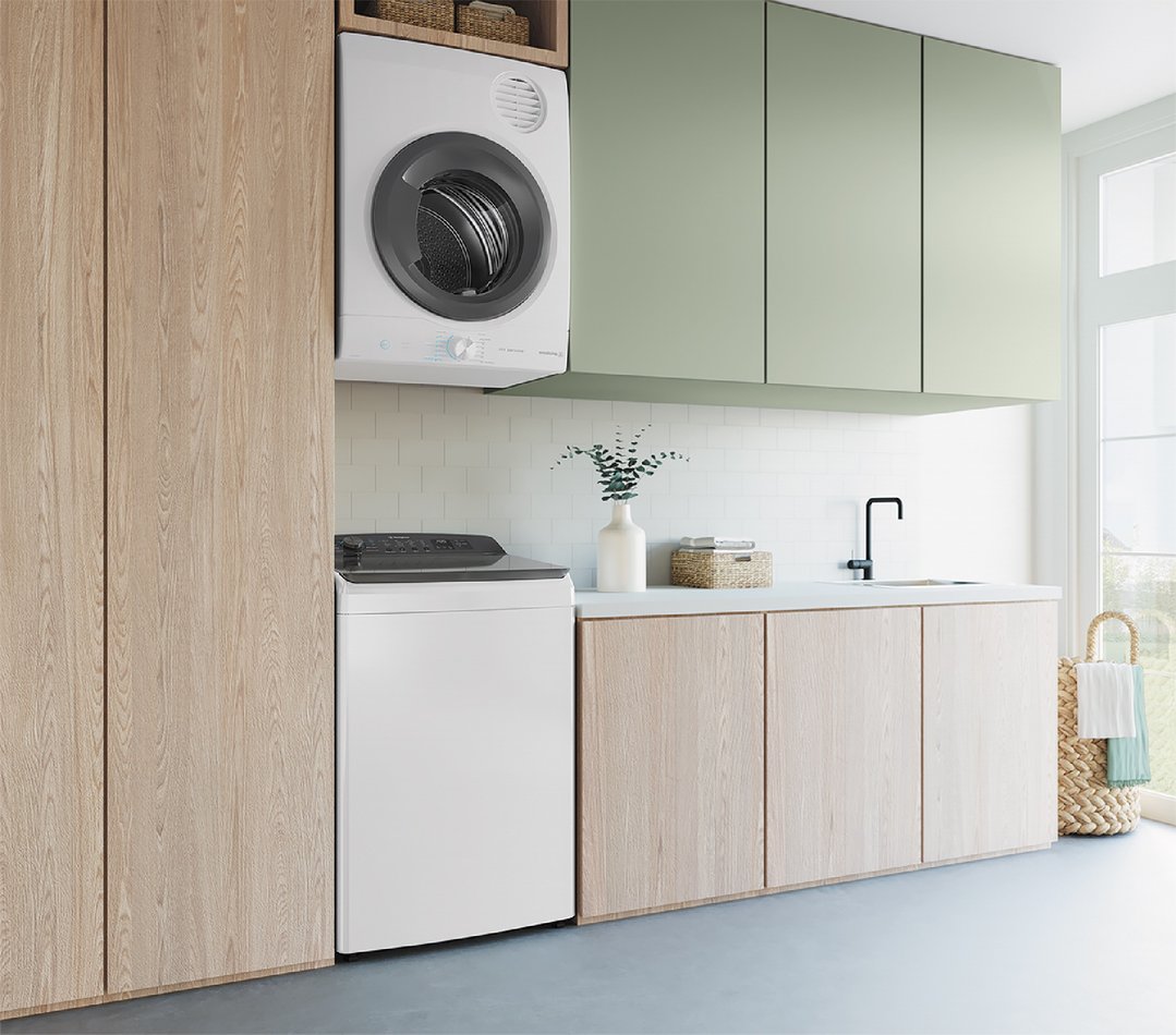 A white top load washing machine in a modern laundry room