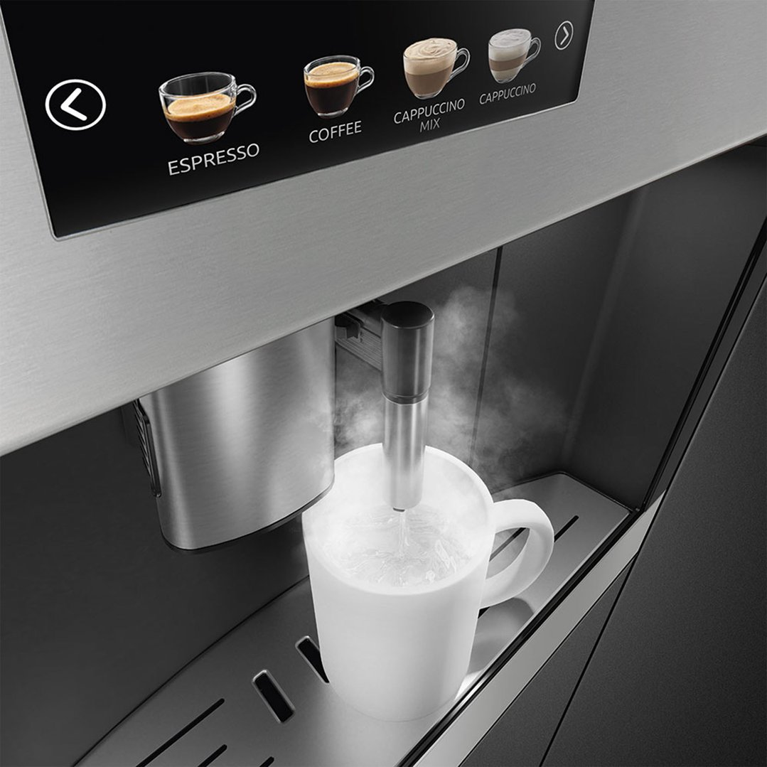 Built-in coffee machine dispensing hot water into a white mug