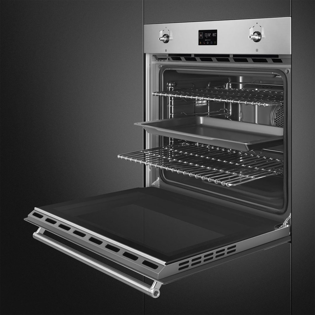 Stainless steel built-in oven with the door partially open, showing racks and tray