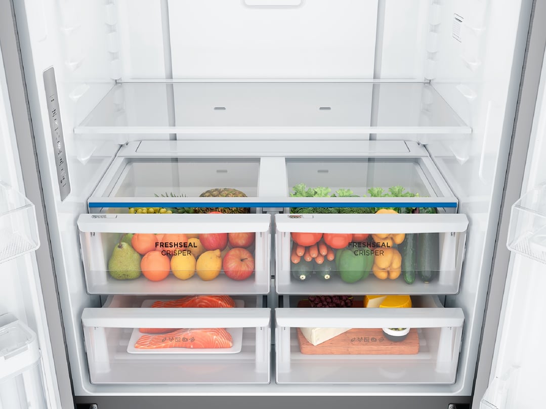 Interior of a fridge with fresh produce, salmon, and cheese in crisper drawers