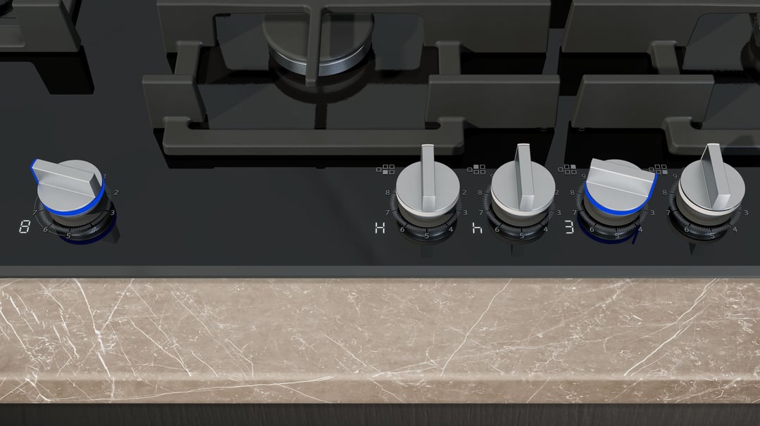 Close-up of a black Siemens iQ700 gas cooktop with five control knobs