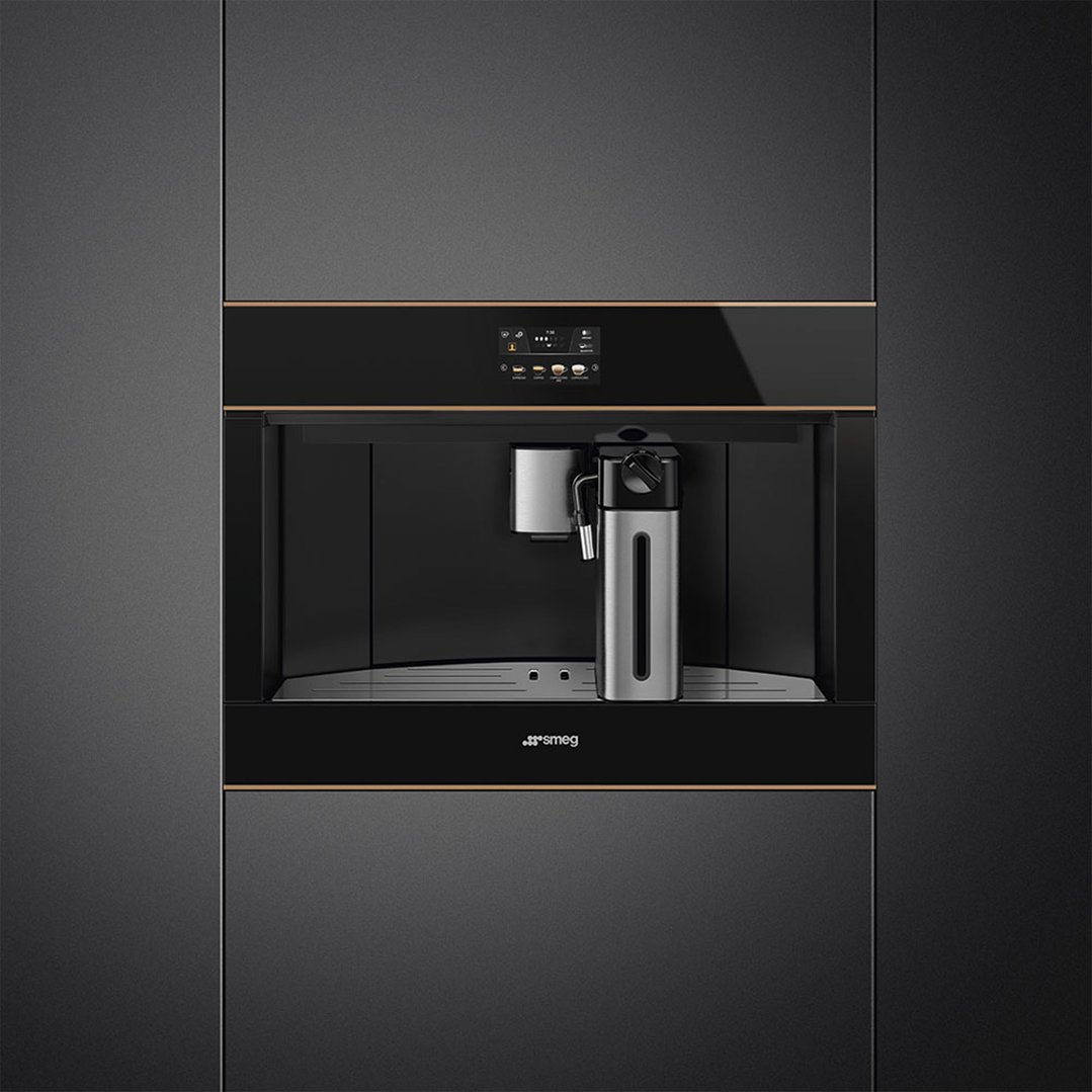 Built-in coffee machine with a milk frother in a dark kitchen setting