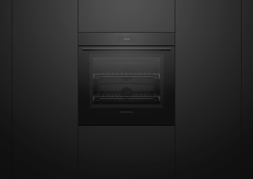 Black glass pyrolytic oven built into dark cabinetry, displaying 19:30 on screen