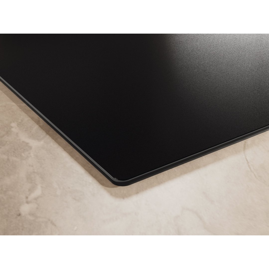 Matte black induction cooktop with SaphirMatt surface on a light marble countertop