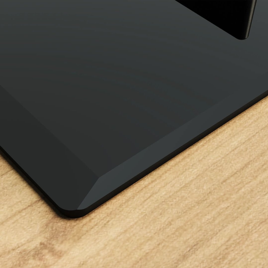 Close up of a black gas cooktop on a light wooden countertop