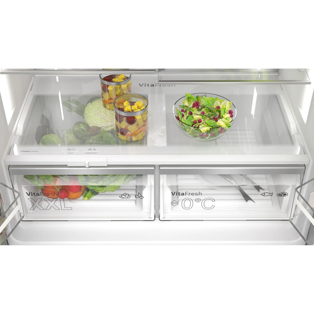 Inside view of a fridge freezer with fresh fruit and vegetables