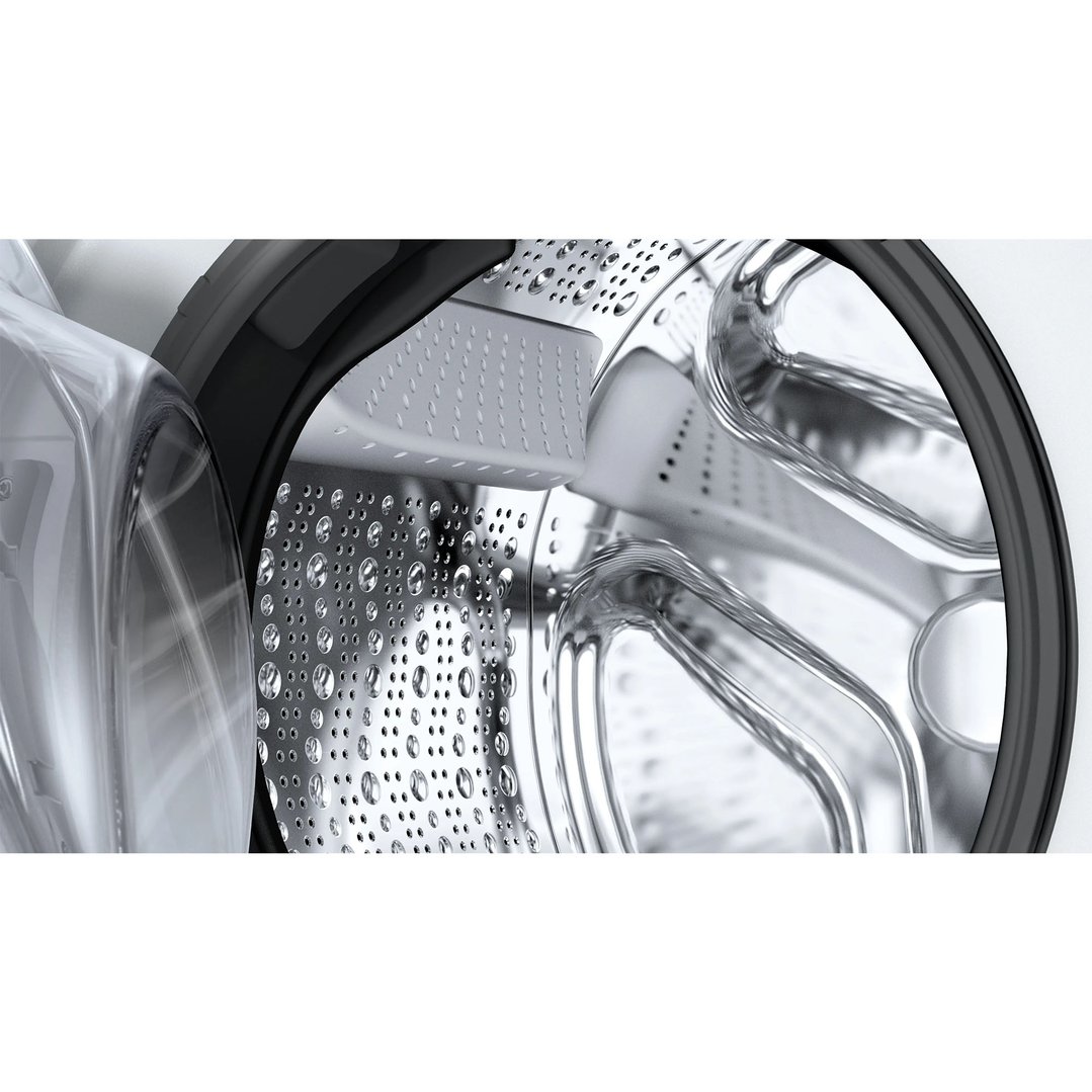 Close up of the washing machine drum with water droplets inside