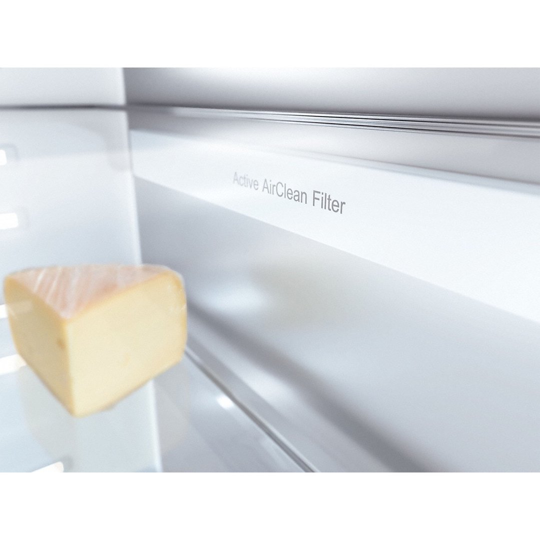 A wedge of cheese on a shelf inside a fridge with an Active AirClean Filter