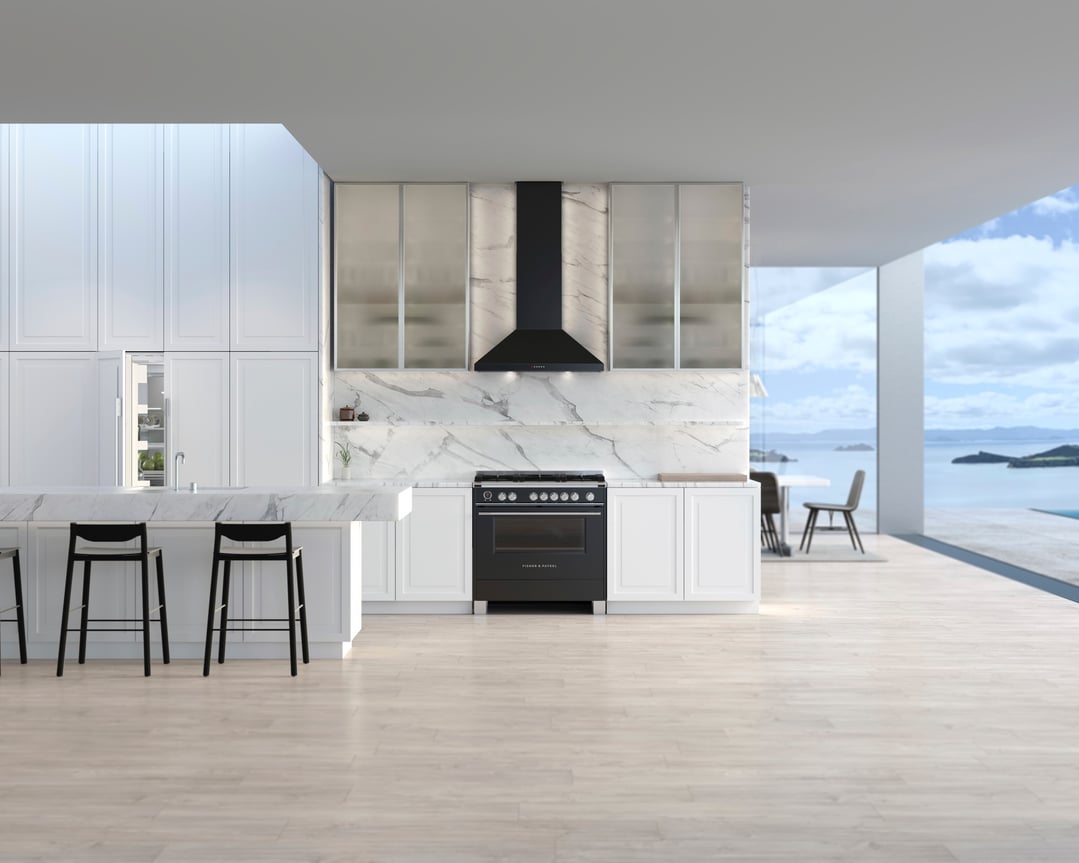 Black freestanding cooker in a modern kitchen with island and ocean view