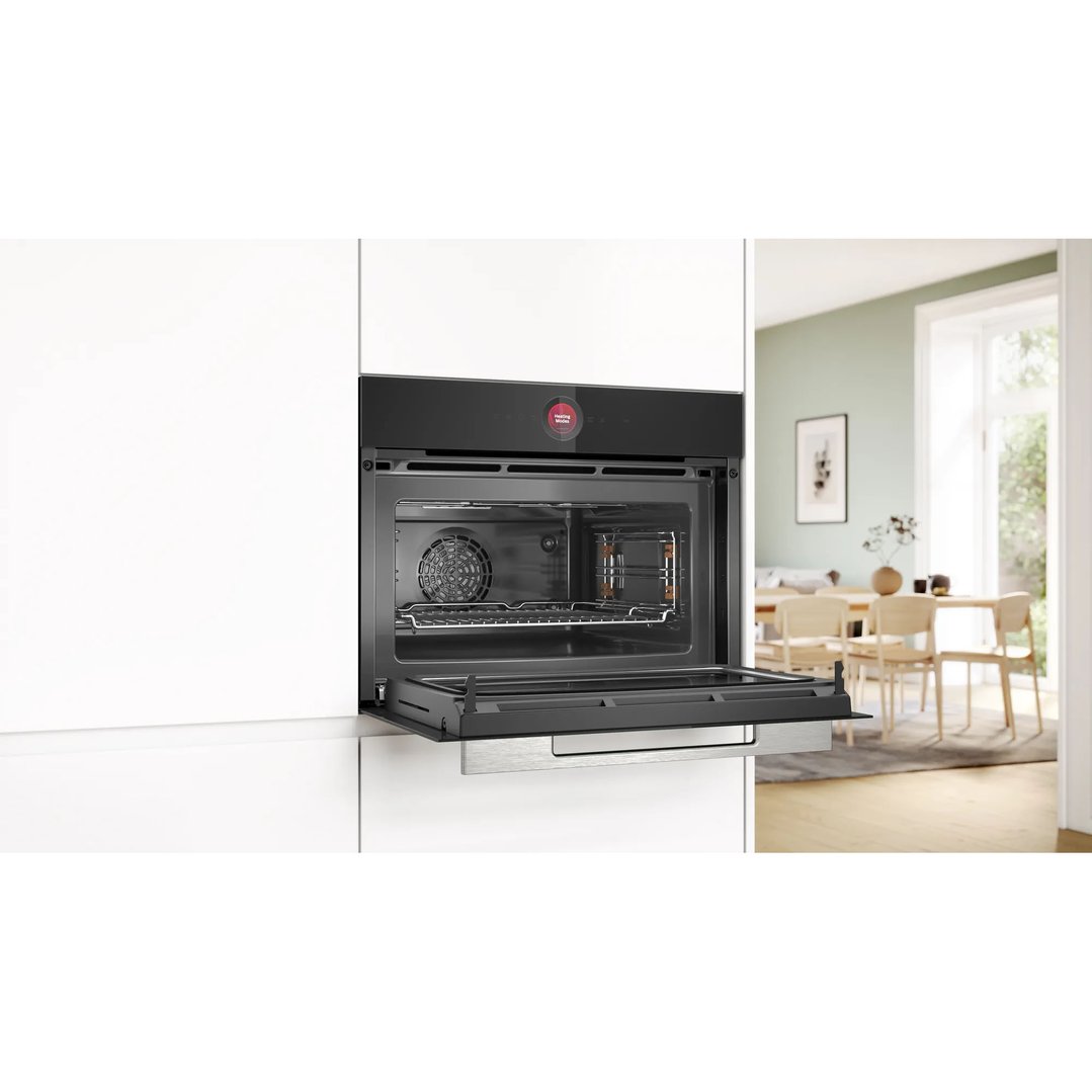Built-in combination oven with microwave in a modern kitchen with open door
