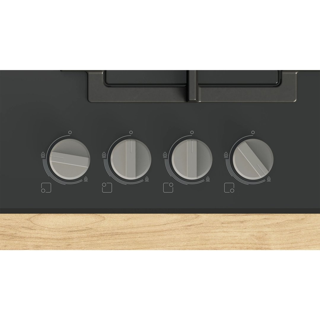 Close up of a black gas cooktop with four control knobs