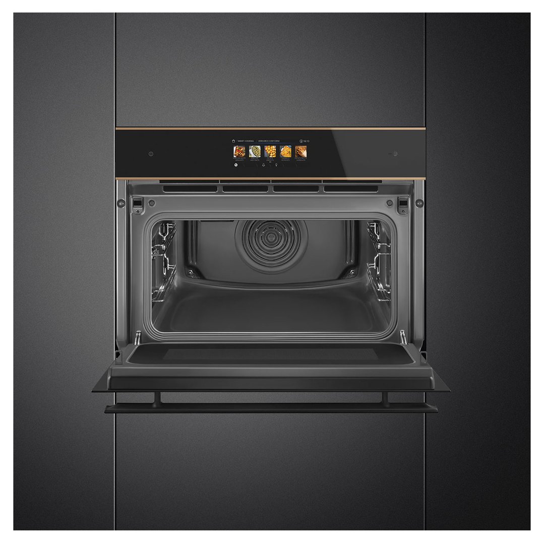 Open microwave oven with a digital display showing cooking options in a dark kitchen