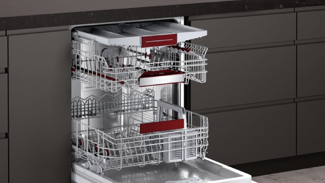 Open built-in dishwasher with racks pulled out in a modern kitchen