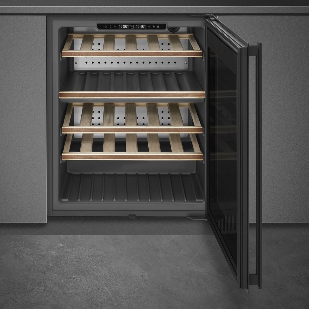 Built-in wine cooler with wooden shelves and open glass door in a kitchen